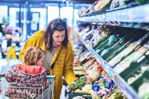 Aldi has cut the prices of more than 40 of its most popular grocery products in an aim to aid any shoppers feeling "squeezed" post-Christmas, here depicting a woman and a child shopping in Aldi
